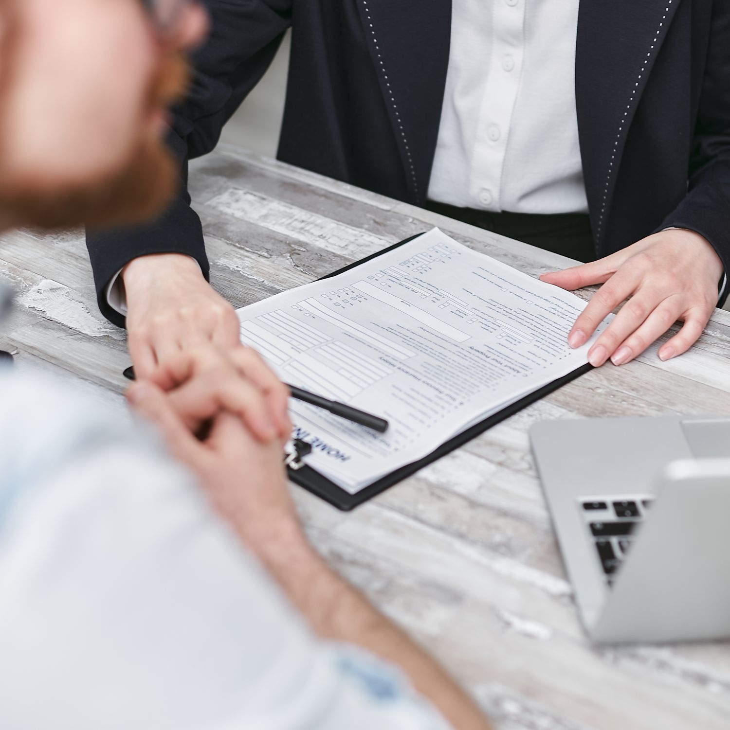 Close-up of a professional discussion around documents