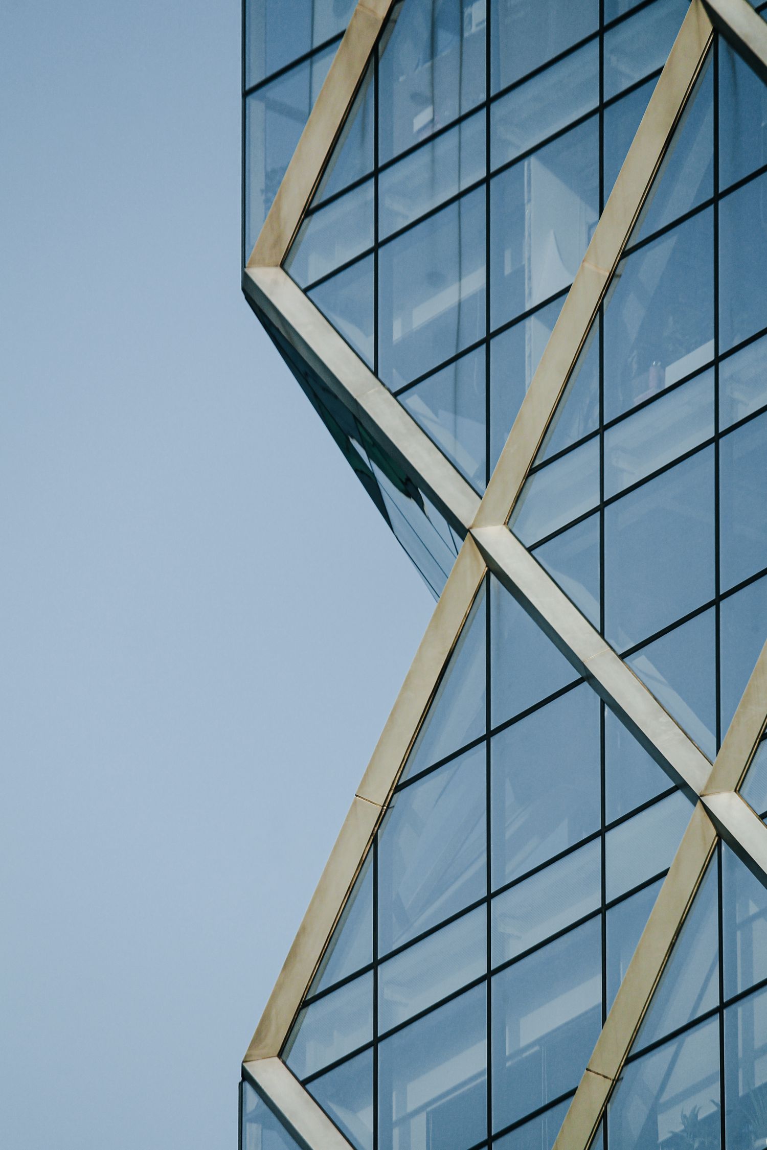 Diagonal lines across a modern glass facade